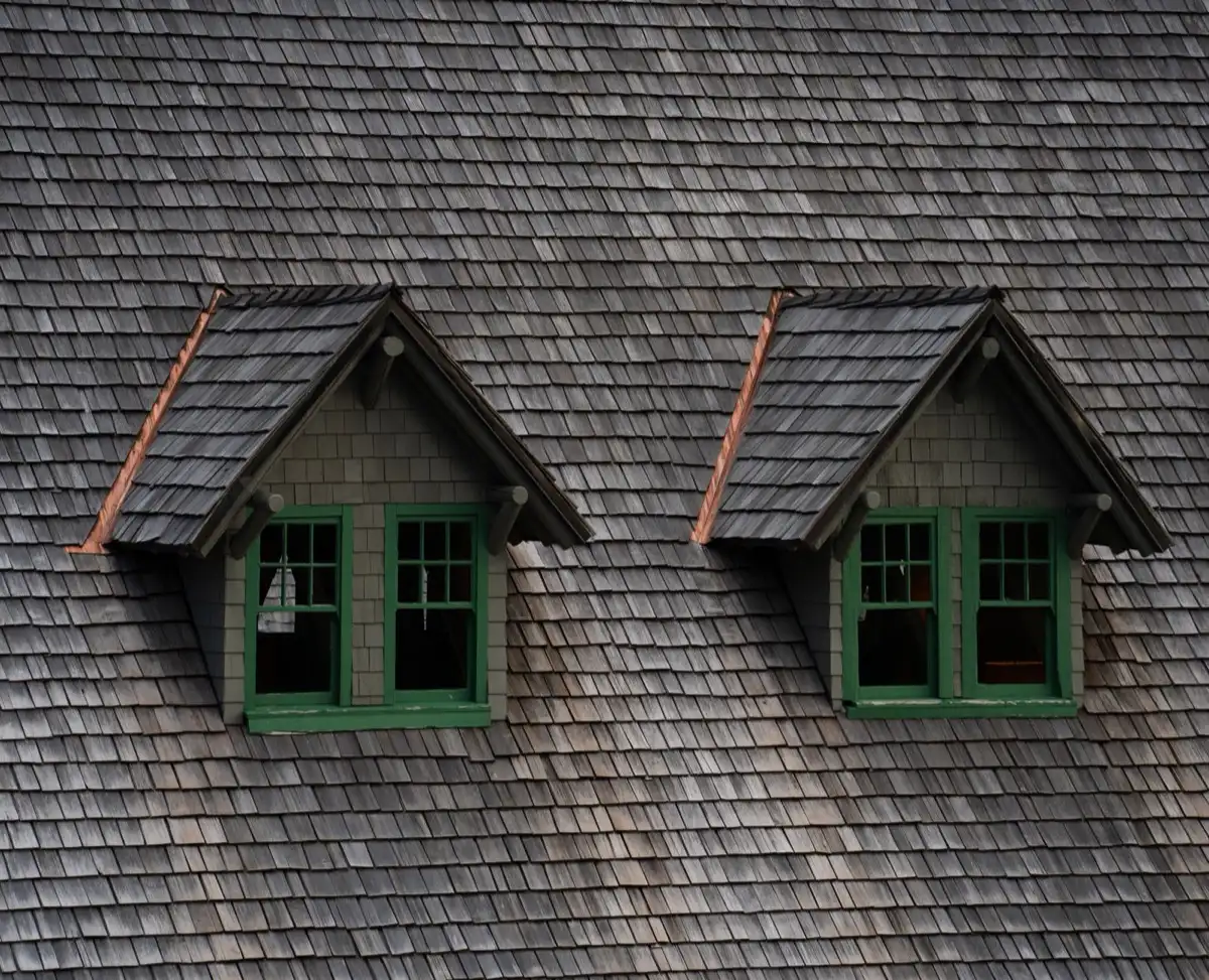 Dormers on a shingle roof in Laredo, TX, where step flashing and kickout flashing carry water past the walls